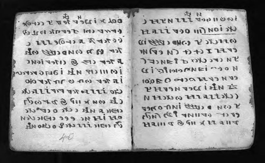 A two-page spread of the Rohonc Codex showing dense rows of symbols across both
      leaves.